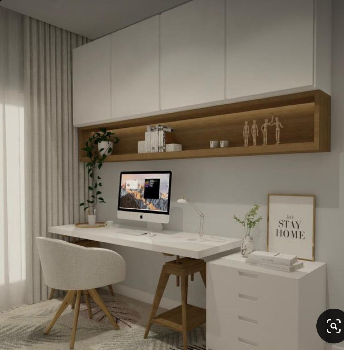 Home office with white desk, wall shelf and natural light
